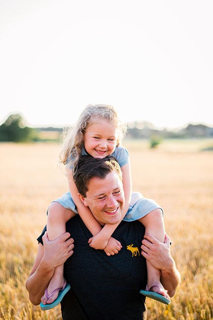 Father hugging daughter outdoor family photo shoot Epsom