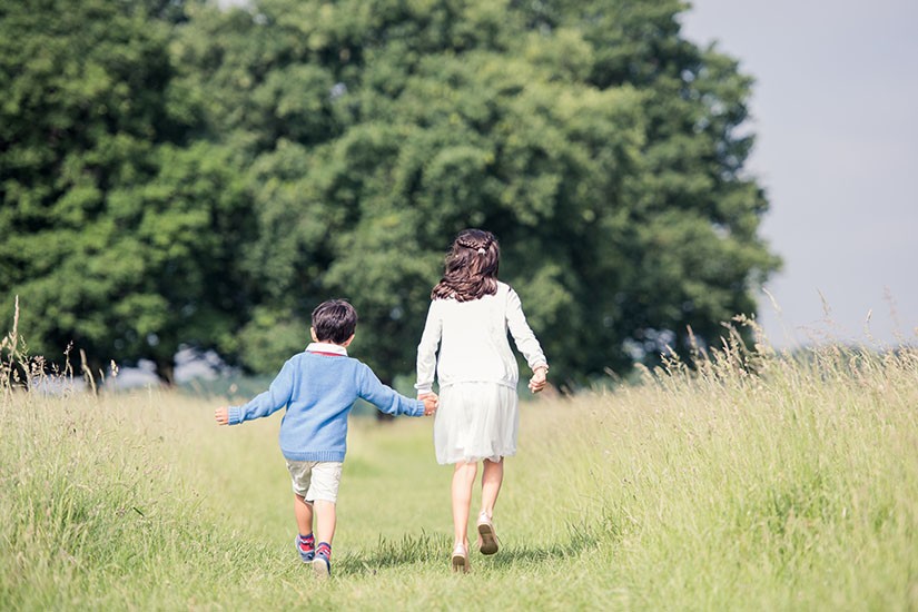 Brother and sister running in outdoor photo shoot Surrey