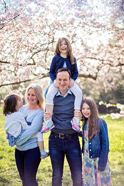 Family giggling in Spring blossom during family photo shoot