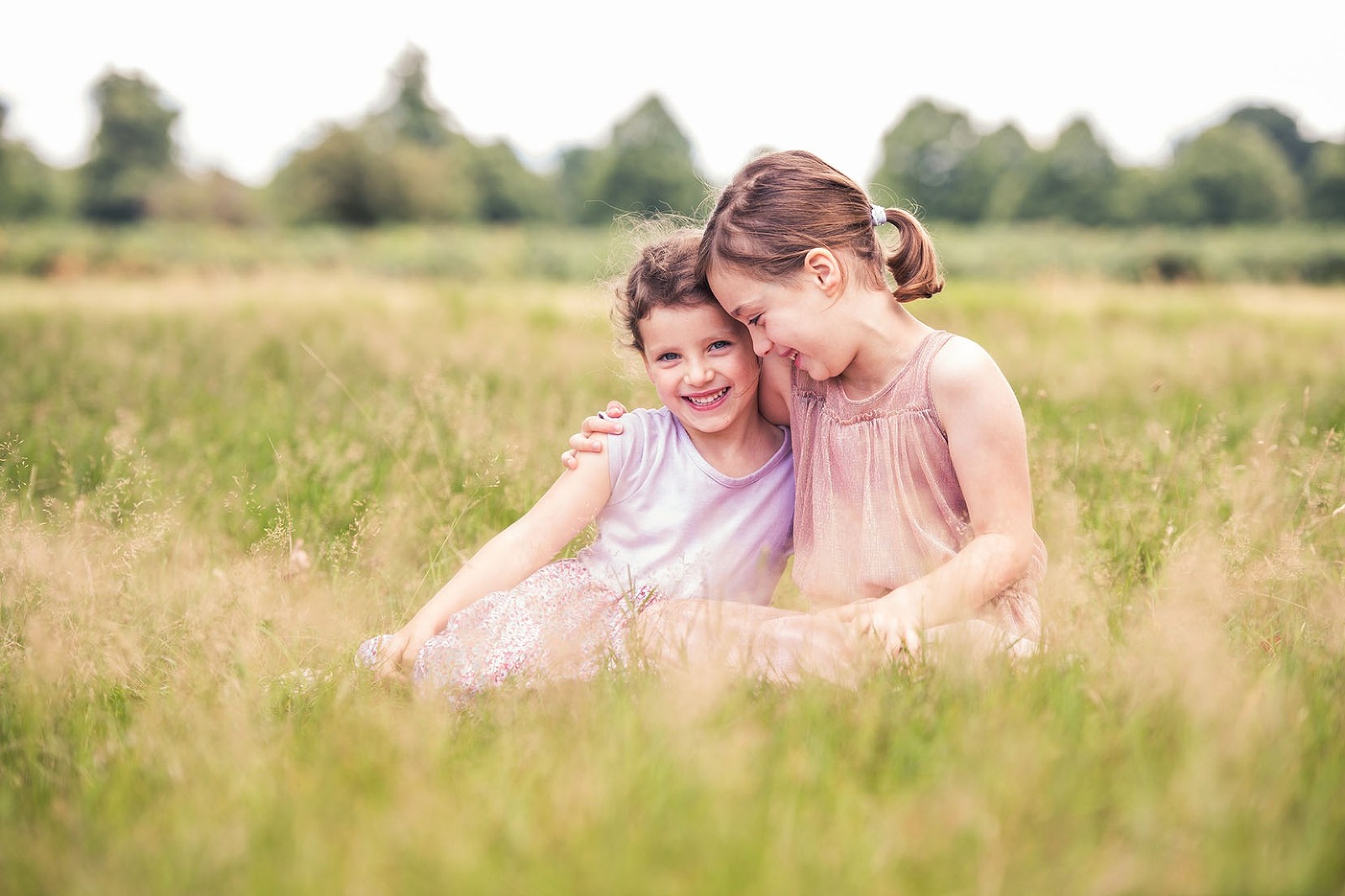 Sisters giggling in family photo shoot Godalming